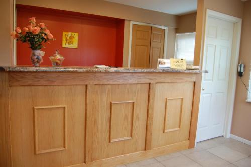 a kitchen with a counter with a vase of flowers at Canton Inn By OYO in Canton