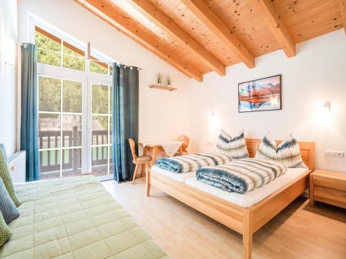 a bedroom with a bed and a large window at Pretty Holiday Home in Hollersbach im Pinzgau with Garden in Hollersbach im Pinzgau