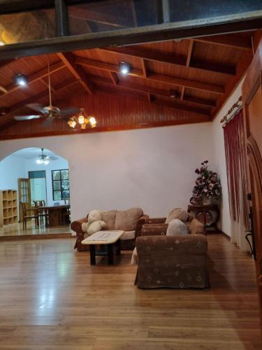 a living room with a couch and a table in it at Kenyalang Lutong Homestay in Miri