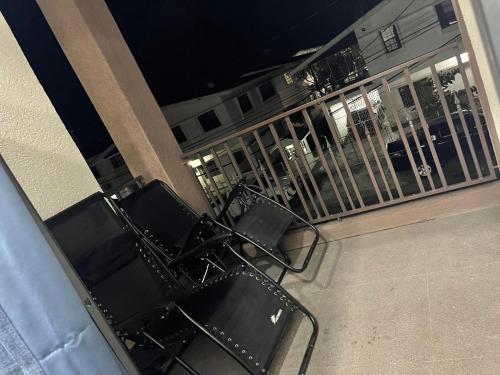 a group of chairs sitting on a balcony at night at APEX BOUTIQUE APARTMENTS in Georgetown