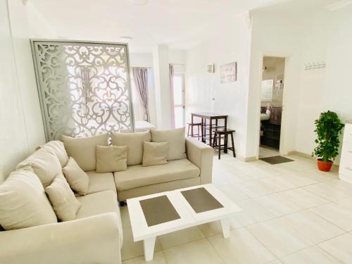 a living room with a couch and a table at Marilyn Studio with Sea View Wi Fi in Hurghada