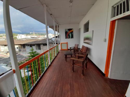 a balcony with chairs and a view of a city at Hotel Arte Santa Rosa in Santa Rosa de Cabal