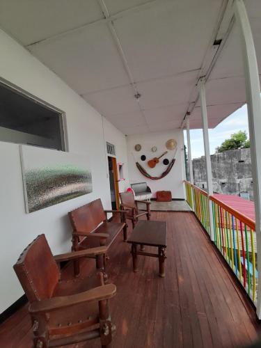 a room with chairs and a television on a balcony at Hotel Arte Santa Rosa in Santa Rosa de Cabal