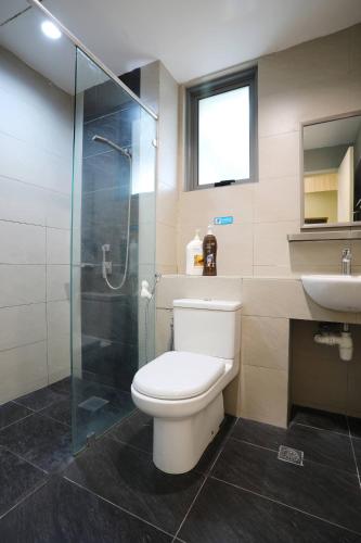 a bathroom with a toilet and a shower and a sink at AJ Suites @ Loft Imago KK in Kota Kinabalu