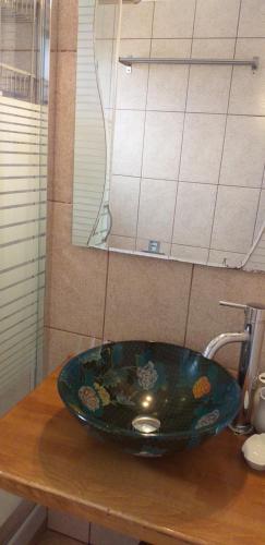 a bathroom sink with a blue bowl on a counter at Barbagiannis House in Ormos Panagias