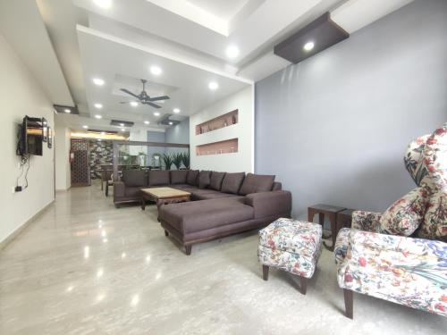 a living room with a couch and chairs at MOON3BHK By Wabi Sabi Stays in Mussoorie