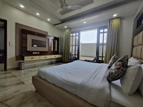a bedroom with a large bed and a television at MOON3BHK By Wabi Sabi Stays in Mussoorie