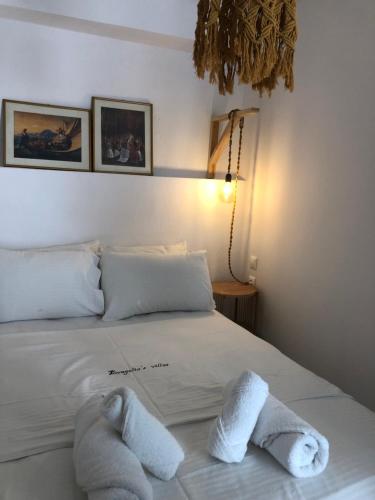 a bedroom with a bed with towels on it at Evagelias suite in Skopelos Town