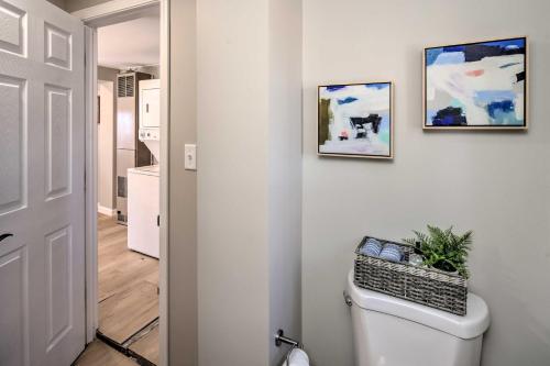 a bathroom with a toilet with two pictures on the wall at Sunny Superior Home - Swim, Hike, and Explore! in Superior