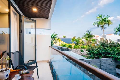 a balcony with a view of the ocean at Aroma Garden Suites Hoi An in Hoi An