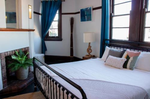 - une chambre avec un grand lit et des rideaux bleus dans l'établissement Charing Cross Hotel, à Sydney