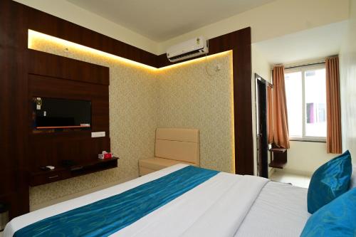 a hotel room with a bed and a television at Hotel Hallmark By THC Group in Kota