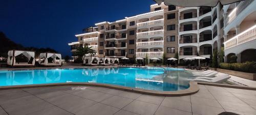 a large swimming pool in front of a building at Valencia Gardens Apartment & Studio, Nesebar in Nesebar