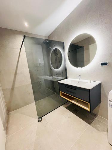 a bathroom with a sink and a mirror at Villa Barovic - Premium apartment in Mlini