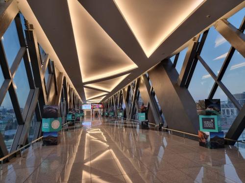 a hallway of a building with a view of the city at Condo Airport NAIA Terminal-3 One Palm Tree Villas in Manila