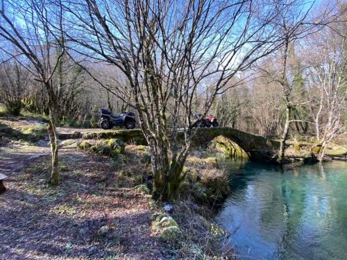 a truck parked on a bridge over a river at Apartments Monte Green in Virpazar