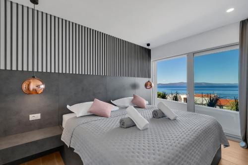 a bedroom with a bed and a large window at Apartman Villa Soll in Drašnice