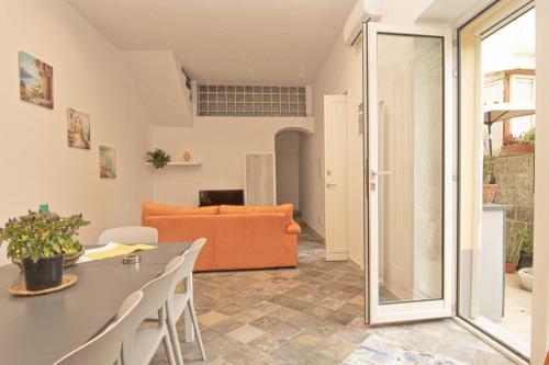 a living room with a table and chairs and a couch at Casa Gelinda tra Sorrento e Positano in Termini