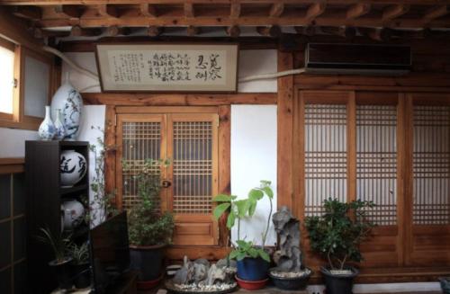 an entrance to a building with plants in pots at Yeon Dang Guesthouse in Seoul