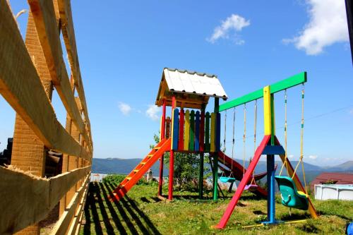 a playground with a slide and a swing at Complex Veverița Rânca in Ranca
