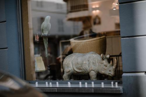 a statue of a rhino on a shelf in a window at Prince Albert Lyon Bercy in Paris