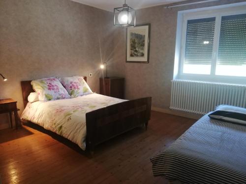 a bedroom with a bed and a window at L'ATELIER DE DESIRE in Cogna