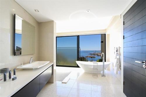 a bathroom with two sinks and a large window at Azamare Guest House in Cape Town