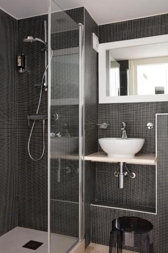 a bathroom with a shower and a sink at Hotel Alcyon in Porto-Vecchio