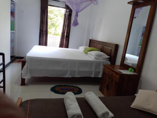 a bedroom with a bed and a large mirror at COCO Rooms in Galle