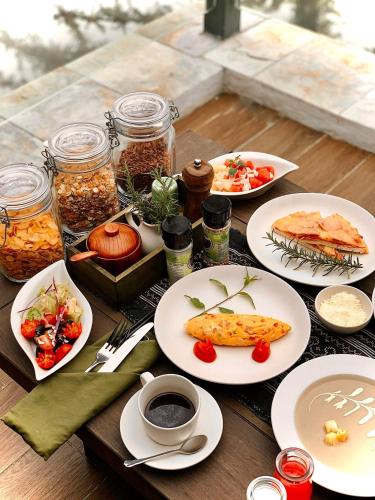 a table topped with plates of food and drinks at Ville De Mont Mountain Resort in Sa Pa