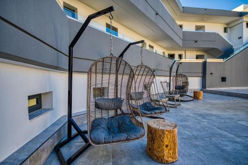 a room with three chairs and a tree stump at Atalanti Boutique Hotel - Adults Only in Faliraki