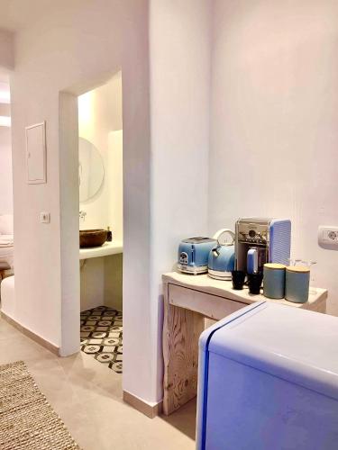 a room with a counter with pots and pans at Oldtown Suites Fira in Fira