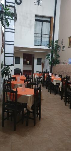 a dining room with tables and chairs in a building at Hotel Real Colonial in Comitán de Domínguez