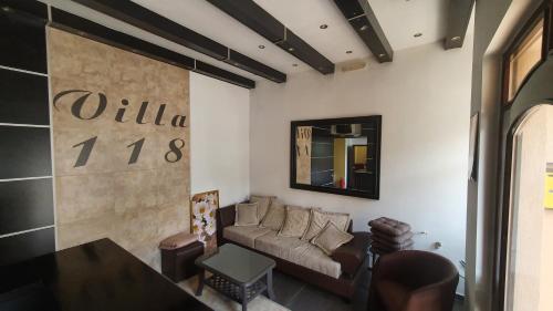 a living room with a couch and a table at Sobe villa 118 in Kragujevac