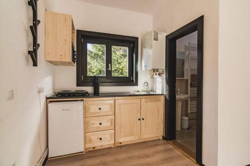 a kitchen with a sink and a window at Birtok Houses - twin no. 2 for 2 people in Borzont