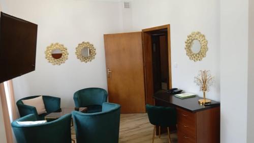a room with chairs and a table and a desk at Hotel Wiosna in Rabka