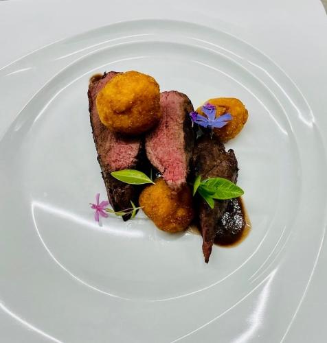 a white plate with some food on it at Hotel Zarja in Pohorje