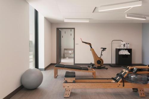 a room with a gym with a treadmill and exercise equipment at OKKO Hotels Paris La Défense in Nanterre