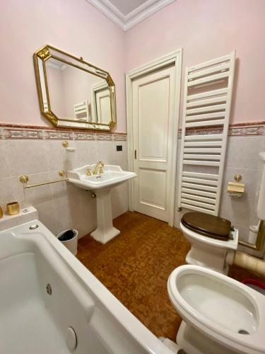 a bathroom with a toilet and a sink and a mirror at Rooftop Garden in Bologna