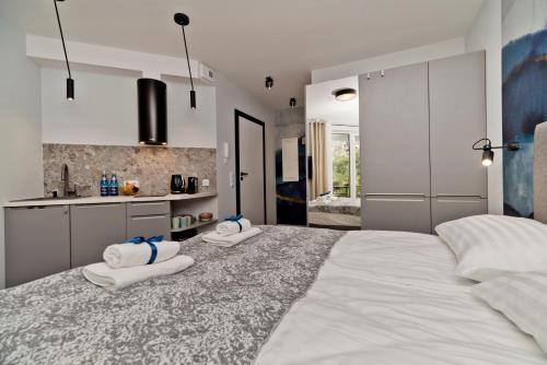 a bedroom with a large bed with towels on it at BlueApart Apartamenty Na Klifie in Władysławowo