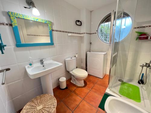 ein Bad mit einem WC, einem Waschbecken und einer Dusche in der Unterkunft Apartamento con jardín Atalaya Canet in Canet d'en Berenguer