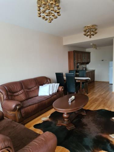 a living room with a couch and a table at Apartman 508 Residence in Donovaly