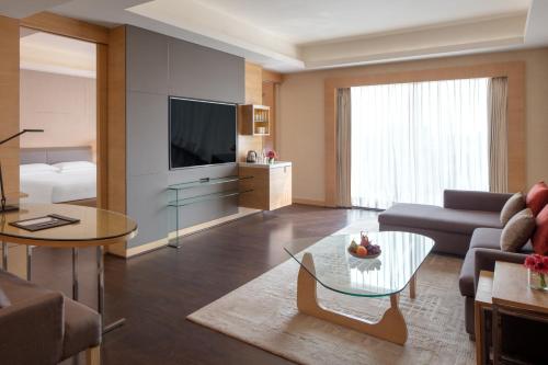 a living room with a couch and a table at Hyatt Regency Chandigarh in Chandīgarh