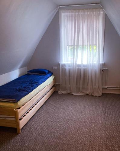 a small bedroom with a bed and a window at Apartaments Ogre. in Ogre