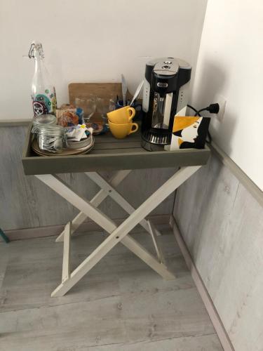a table with a coffee maker on top of it at Les Landes in Saint-Pardoux-Corbier