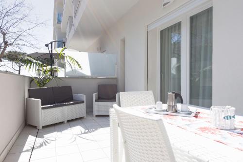 a patio with a table and chairs on a balcony at Residence Armony in Misano Adriatico