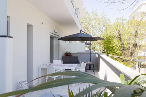 a balcony with a table and an umbrella at Residence Armony in Misano Adriatico