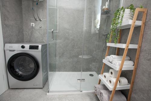 a washing machine in a bathroom with a shower at Luxury apartment Eva in Zadar