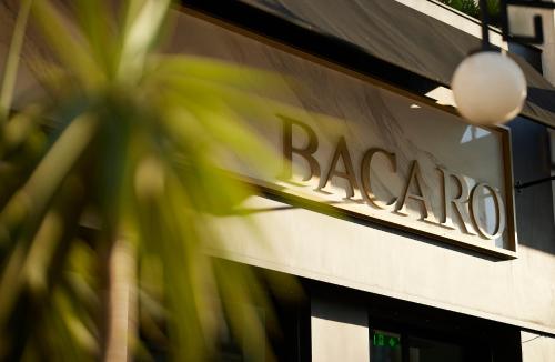 a sign on the side of a bago store at The Port Square Hotel in Piraeus