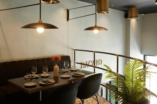 a table in a restaurant with glasses of wine at The Port Square Hotel in Piraeus